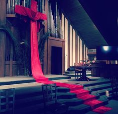 an empty church with pews and red carpet on the floor in front of it