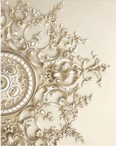 an intricately designed wallpaper with white flowers and leaves on the bottom half of it