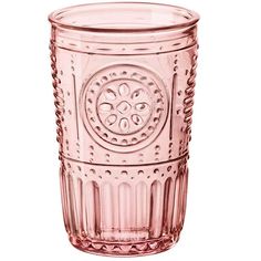 a pink glass cup sitting on top of a white table