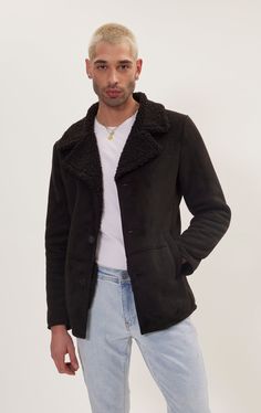 Our vegan shearling button closure jacket is an ethical and stylish choice for keeping warm and comfortable during the cooler seasons.Unlike traditional shearling, which is made from sheepskin, vegan shearling is crafted from synthetic materials that mimic the look and feel of real shearling. This makes it an animal-friendly option without compromising on softness or warmth. Made from super soft vegan leather and inner shearling. Cut close for a TAPERED, streamlined fit, this jacket provides a lightweight supple feel for year round wear. With a zipper closure that runs the length of the jacket, this edgy design pairs well with just about any outfit for an added statement. SIZE + FIT Tailored fit, to find your correct size use the ''what's my size '' button. COMPOSITION 100% PolyesterMade i Edgy Design, Jackets Men Fashion, Synthetic Materials, Jacket Style, Keep Warm, Vegan Leather, How To Wear, Black