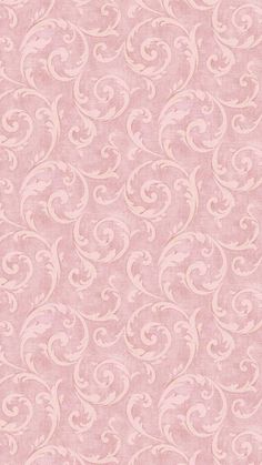 a pink wallpaper with white swirls and scrolls on the bottom half of it