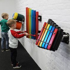 two young boys playing with colorful musical instruments