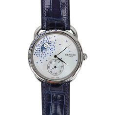 Guaranteed authentic Hermes Arceau Petite Lune Watch featured in the 38 mm large model.This beautiful diamond and sapphire set watch has gems sprinkled on the bezel and on the mother of pearl dial. The moon phase indicator has a blue background and rhodium plated decoration.Steel case is et with 22 (0.25ct) blue sapphires and 10 (0.008 ct) diamonds.Mother of Pearl dial is set with a gem count of 65 (1.188ct) blue sapphires and 58 (0.058ct) diamonds.Interchangeable strap is Blue Sapphire alligato Luxury Blue Watches For Evening, Luxury Blue Evening Watch, Blue Diamond Watch With Diamond Hour Markers, Hermes Watch, Hermes Box, Watch Sale, Sapphire Diamond, Moon Phases, Blue Background