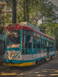 an old bus is parked on the side of the road