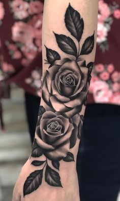 a black and white rose tattoo on the arm