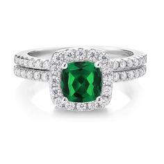 an emerald and diamond ring set in white gold