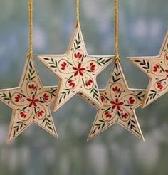 three wooden star ornaments hanging from chains