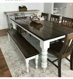 a dining room table with two benches in front of it