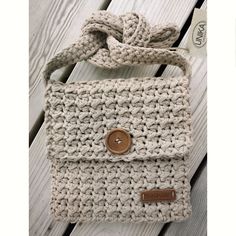 a crocheted purse with a button on it