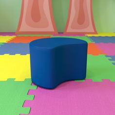 a blue stool sitting on top of a colorful floor