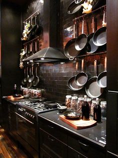 a kitchen with pots and pans hanging on the wall