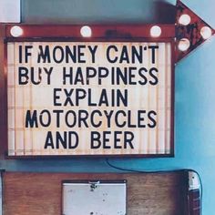 a sign that says if money can't buy happiness, explain motorcycles and beer