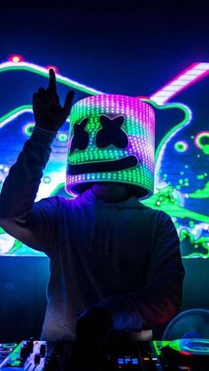 a person wearing a hat and lights on their face in front of a neon background