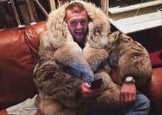 a man in a fur coat sitting on a couch