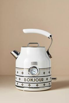 a white tea kettle sitting on top of a table