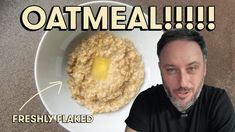 a man sitting in front of a bowl of oatmeal with an egg on top