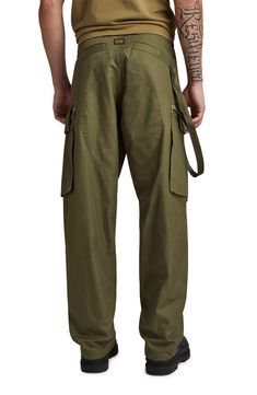 These loose-fitting, military-inspired twill pants feature roomy cargo pockets and woven tape inside the hems that can be adjusted to slightly taper the legs. Zip fly with button and drawstring closure Front slant pockets; side flap-patch zip pockets; back welt pockets 100% cotton Machine wash, line dry Imported Combat Style Cotton Parachute Pants With Straight Leg, Combat Style Cotton Parachute Pants, Cotton Combat Parachute Pants With Straight Leg, Baggy Military Cargo Pants With Patch Pockets, Military Style Cotton Parachute Pants With Multiple Pockets, Military Style Baggy Pants With Patch Pockets, Khaki Techwear Parachute Pants With Hip Pockets, Khaki Parachute Pants With Hip Pockets In Techwear Style, Urban Style Tapered Leg Parachute Pants