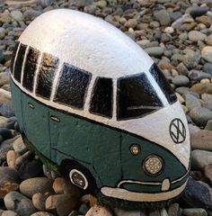 a green and white vw bus painted on rocks