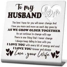 a white plaque with the words to my husband on it and hearts in black ink