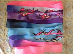 five different colored headbands with designs on them