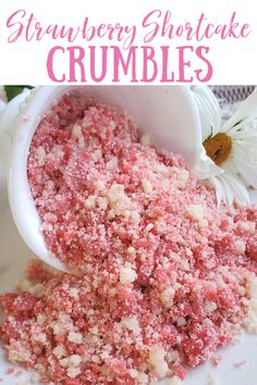 strawberry shortcake crumbles in a white bowl on a plate with daisies