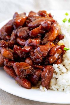 a white plate topped with rice and meat