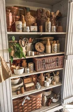 an old cupboard filled with lots of different types of kitchen utensils and other items