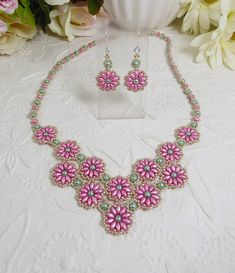 "Woven flower necklace and earrings in pink. Gifts for her. This hand woven, V style flower necklace and earrings set uses rose pink Super Duo beads, crystal pearls in a lovely spring green that are woven with permanent finish silver seed beads. The woven rope highlights a double row of adorable daisy flowers. The necklace measures 19\" long with an easy to fasten spring ring clasp.  The coordinating earrings are approximately 1.75\" from the top of the hook style ear wires. A lovely springtime Super Duo Beads, V Style, Duo Beads, Super Duo, Daisy Flowers, Blue Gifts, Earrings Pink, Pink Gifts, Wedding Jewelry Sets