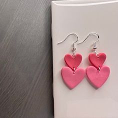 These are handmade polymer clay earrings. This listing is for the heart stack dangle pair. For the coordinating smaller stud pair to match with a little girl in your life, click the following link: https://www.etsy.com/listing/1512503815/pink-heart-clay-earrings-polymer-clay Pink Polymer Clay Birthday Earrings, Pink Polymer Clay Earrings For Birthday, Valentine's Day Polymer Clay Dangle Jewelry, Cute Polymer Clay Earrings For Valentine's Day, Handmade Polymer Clay Heart Earrings Gift, Pink Clay Jewelry For Gifts, Polymer Clay Heart Earrings As Valentine's Day Gift, Polymer Clay Heart Earrings For Valentine's Day Gift, Valentine's Day Gift Polymer Clay Heart Earrings