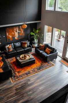 40 Cozy Black Living Room Ideas for a Comfortable Retreat Black Couch Wood Floors, Black White Orange Living Room, Orange And Black Living Room, Cozy Black Living Room, Black Leather Sofa Decor, Black Leather Sofa Living Room Decor, Dark Brown Room, Brown Room Ideas, Black Leather Sofa Living Room