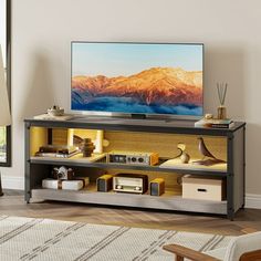 a flat screen tv sitting on top of a wooden shelf