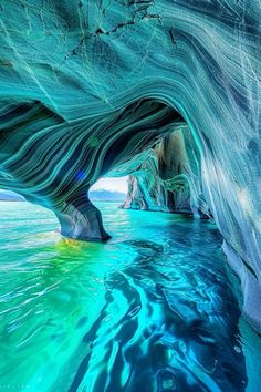 the inside of an ice cave with blue water