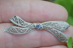 This is a wonderful delicate in design pin. It is crafted from 14K white gold and dates from the 1920's/30's. The condition is excellent. The bow is done in filigree work which was popular at that time. The filigree is very intricate with a fabulous pattern. The bow is three dimensional and features a round cut blue sapphire which is in a raised bezel setting. The stone is a lovely deep blue and in wonderful condition. The back of the pin features a locking clasp which functions perfectly for a Circle Bracelet, White Gold Sapphire, Gorgeous Bracelet, Bezel Setting, Deep Blue, Three Dimensional, Blue Sapphire, Brooches, Vintage Items