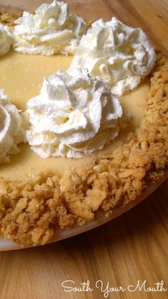 a close up of a pie with whipped cream on top