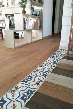 a room with wooden floors and bookshelves in it