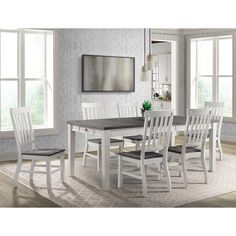 a dining room table and chairs in front of windows