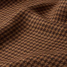 close up view of brown and black checkered fabric