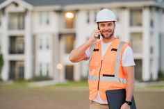 Builder using phone. Portrait of builder man. Construction worker with hardhat helmet on construction site. Construction stock photo Using Phone, Construction Management, Photo Site, Construction Worker, New Home Construction, Construction Site, Clipboard, Hard Hats, Vector Icons