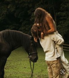 a man and woman are standing next to a horse