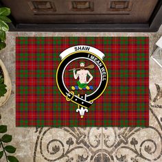 shaw tartan door mat with clan crest and plaid pattern on the front, featuring an image of a man in a kilt