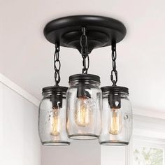 three mason jar lights hanging from the ceiling