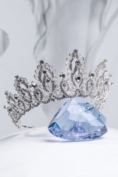 As a professional in the industry, I am pleased to present our luxurious silver tiara. Made with precision and expertise, this tiara exudes elegance and sophistication. With its stunning gold color, it will add a touch of luxury to any outfit. Wear this tiara confidently and make a statement at any event. Size: height tiara - 2.75" ( 7 cm); the length of the decorative part - 16" ( 41cm). Tiara Wedding Hair, Crystal Crown Tiaras, Tiara Gold, Tiara Silver, Swarovski Tiara, Crystal Wedding Tiaras, Silver Tiara, Pearl Tiara, Royal Tiaras