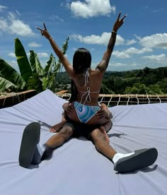 a woman sitting on top of a white sheet