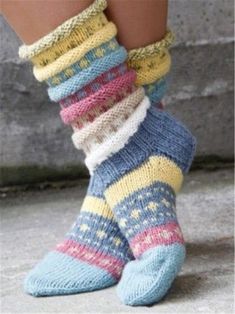 a woman's legs wearing socks with multicolored knits on the bottom