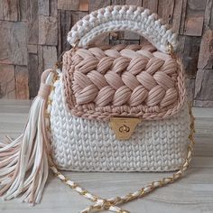 a white and pink purse sitting on top of a table