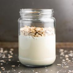 a glass jar filled with oatmeal sitting on top of a table