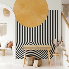 a living room with black and white stripes on the wall next to a wooden bench