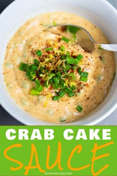 a white bowl filled with crab cake sauce and topped with green onion sprinkles