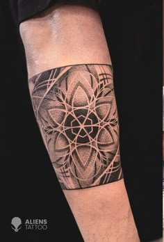 a man with a black and white tattoo on his arm next to an image of a flower