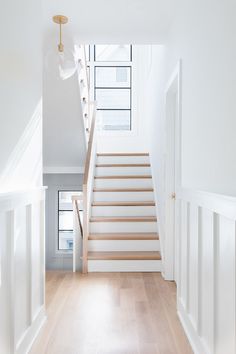 an empty room with white walls and stairs